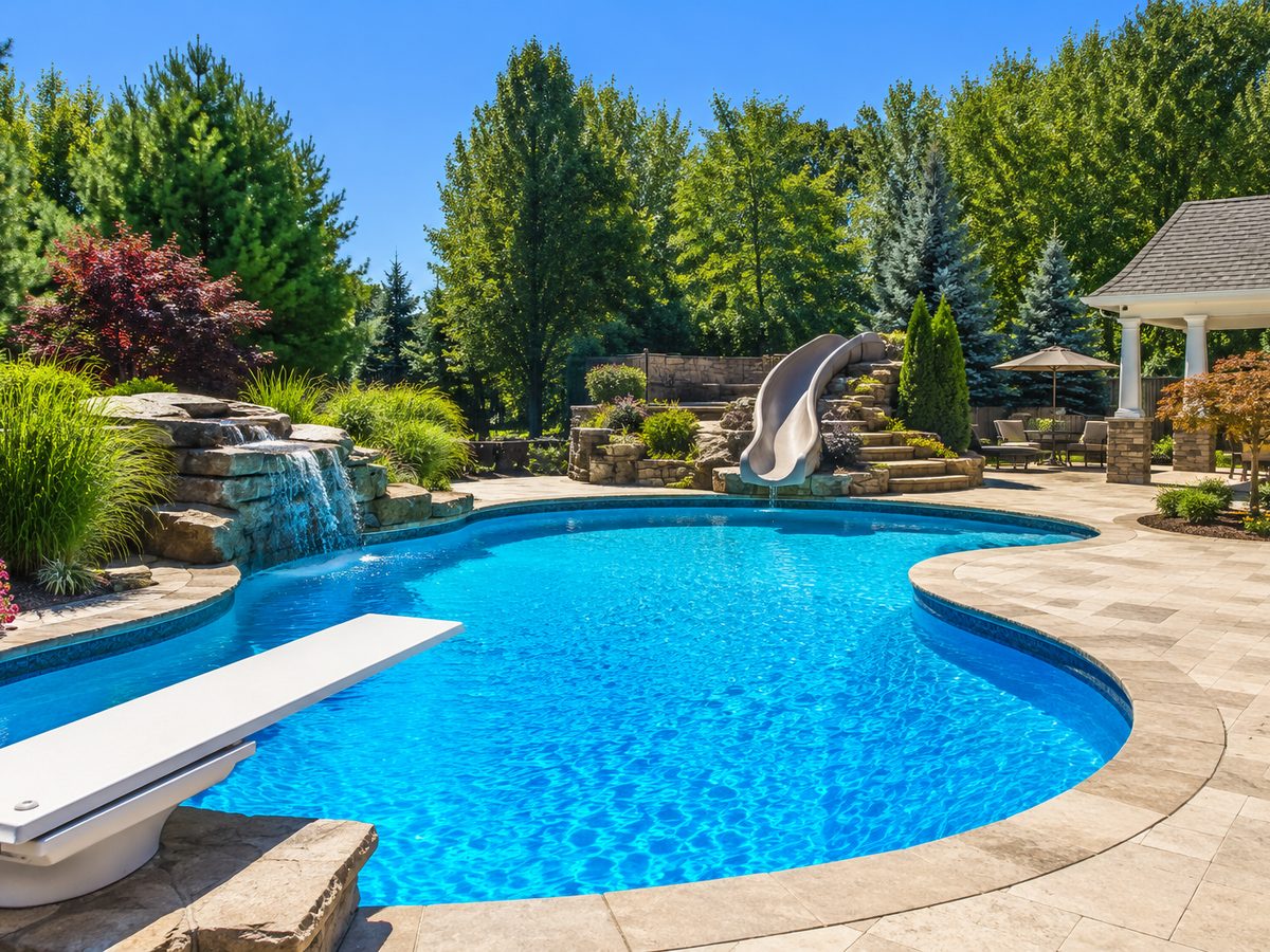 Family pool with diving board, slide, and gazebo